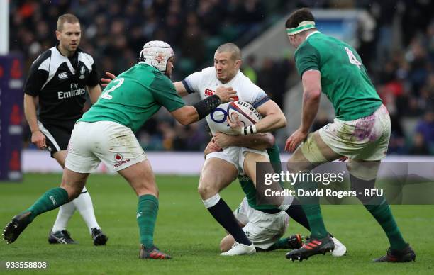 Mike Brown of England is tackled by Rory Best during the NatWest Six Nations match between England and Ireland at Twickenham Stadium on March 17,...