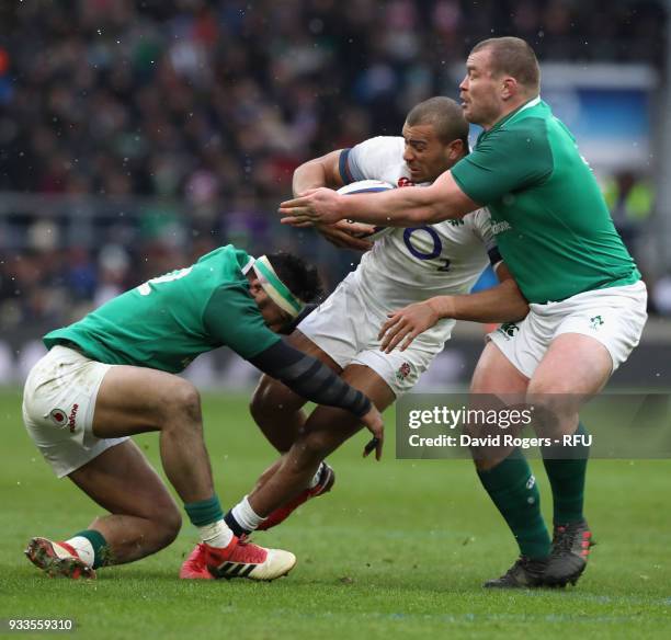 Jonathan Joseph of England is tackled by Bundee Aki and Jack McGrath during the NatWest Six Nations match between England and Ireland at Twickenham...