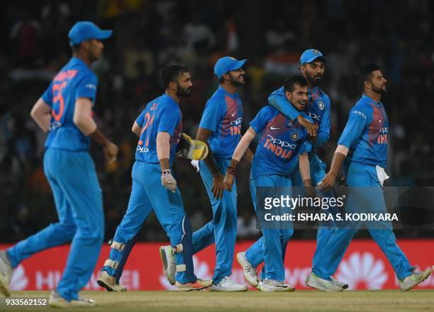 Indian cricketer Yuzvendra Chahal celebrates with teammates after he dismissed Bangladeshi cricketer Soumya Sarkar during the final Twenty20...
