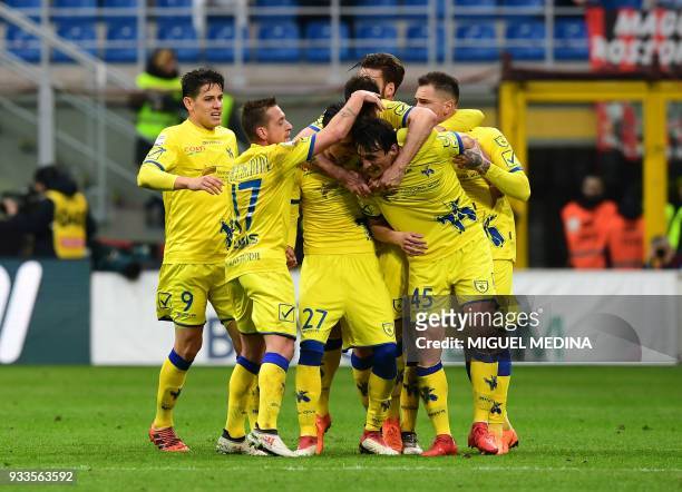 Chievo's Italian forward Roberto Inglese is congratulated by teammates after scoring during the Italian Serie A football match AC Milan vs AC Chievo...