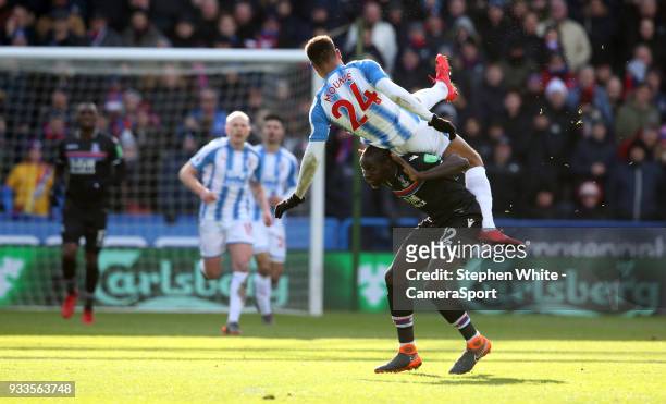 Crystal Palace's Mamadou Sakho tangles with Huddersfield Town's Steve Mounie during the Premier League match between Huddersfield Town and Crystal...