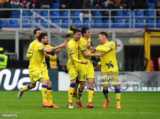 Chievo's Italian forward Roberto Inglese is congratulated by teammates after scoring during the Italian Serie A football match AC Milan vs AC Chievo...