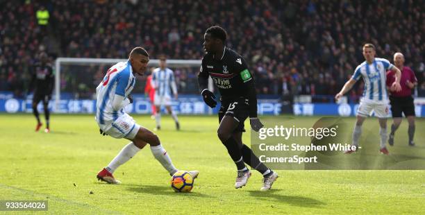 Crystal Palace's Mamadou Sakho battles with Huddersfield Town's Collin Quaner during the Premier League match between Huddersfield Town and Crystal...