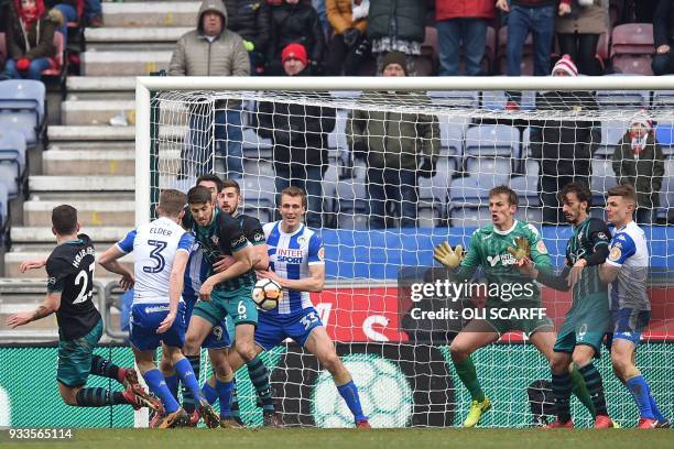 Southampton's Danish midfielder Pierre-Emile Hojbjerg watches as his shot beat Wigan Athletic's English goalkeeper Christian Walton for the first...