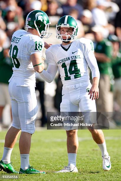 Brett Swenson place kicker for the Michigan State Spartans is congratulated after a field goal by place holder Aaron Bates during action against the...