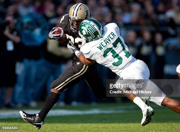 Jaycen Taylor of the Purdue Boilermakers is tackled from the side by Ross Weaver of the Michigan State Spartans at Ross-Ade Stadium on November 14,...
