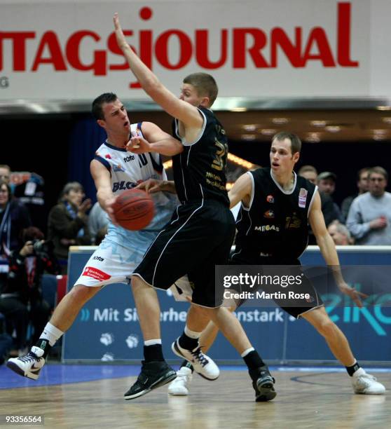 Philipp Schwethelm of Bremerhaven is attacked by Matt Stucki and Nikita Khartchenkov of Mitteldeutscher BC during the Beko Basketball Bundesliga game...