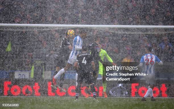 Crystal Palace's James Tomkins battles with Huddersfield Town's Thomas Ince during the Premier League match between Huddersfield Town and Crystal...