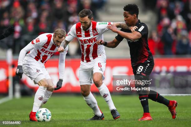 Marco Hoger of 1.FC Koeln and Wendell of Bayer Leverkusen battle for the ball during the Bundesliga match between 1. FC Koeln and Bayer 04 Leverkusen...