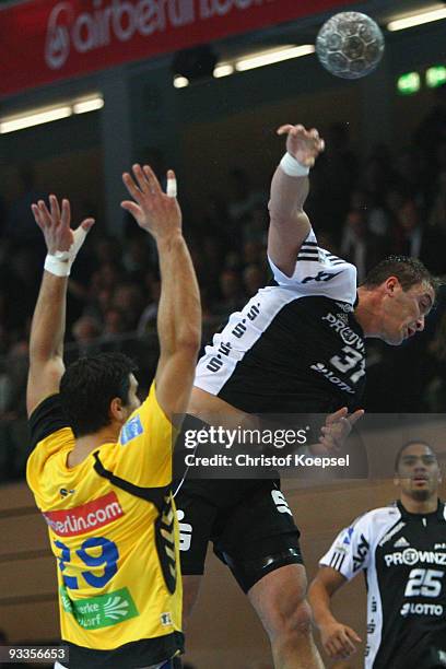 Frantisek Sulc of Duesseldorf blocks a throw of Momir Ilic of Kiel during the Toyota Handball Bundesliga match between HSG Duesseldorf and THW Kiel...