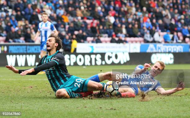 Manolo Gabbiadini of Southampton is fouled by Dan Burn of Wigan Athletic for a penalty during The Emirates FA Cup Quarter Final match between Wigan...