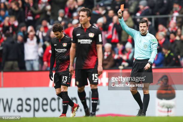 Lucas Alario of Bayer Leverkusen is shown a red card by referee Harm Osmers during the Bundesliga match between 1. FC Koeln and Bayer 04 Leverkusen...
