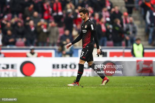 Lucas Alario of Bayer Leverkusen walks off the pitch after receiving a red card from referee during the Bundesliga match between 1. FC Koeln and...