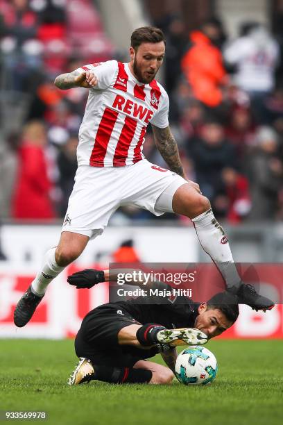 Marco Hoger of 1.FC Koeln and Charles Aranguiz of Bayer Leverkusen battle for the ball during the Bundesliga match between 1. FC Koeln and Bayer 04...