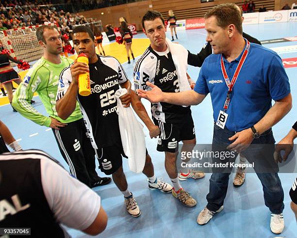 Head coach Alfred Gislason of Kiel speaks to Thierry Omeyer , Daniel Narcisse and Dominik Klein during the Toyota Handball Bundesliga match between...