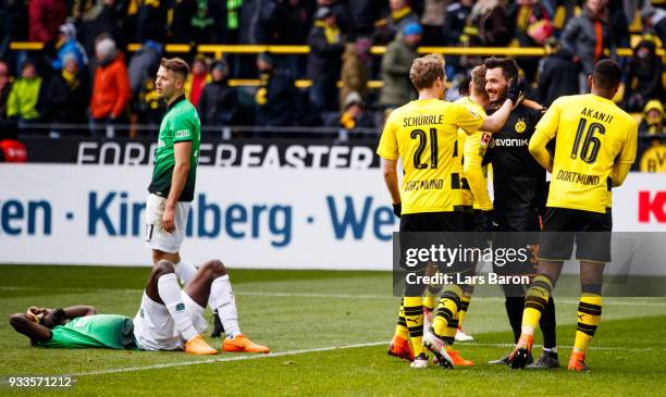 Andre Schuerrle of Dortmund celebrates with goalkeeper Roman Buerki of Dortmund after winning the Bundesliga match between Borussia Dortmund and...