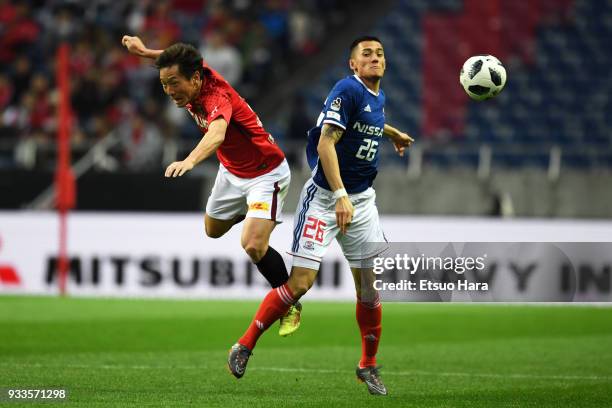 Tomoya Ugajin of Urawa Red Diamonds and Ippei Shinozuka of Yokohama F.Marinos compete for the ball during the J.League J1 match between Urawa Red...