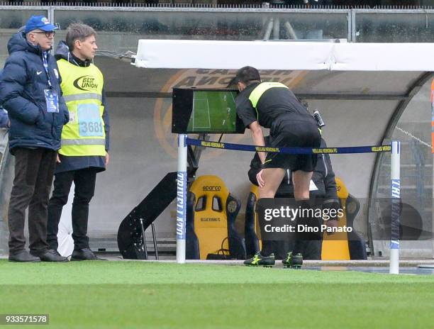 Referee Marco Di Bello looks VAR during the serie A match between Hellas Verona FC and Atalanta BC at Stadio Marc'Antonio Bentegodi on March 18, 2018...