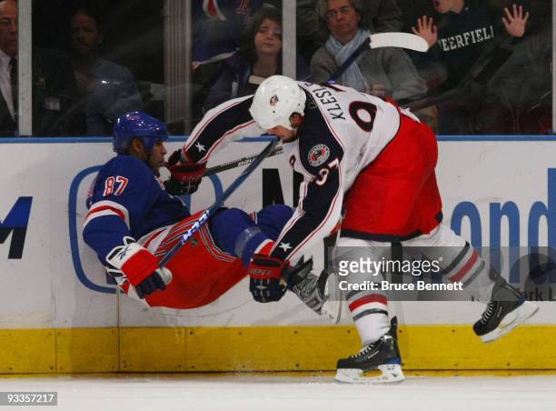Rostislav Klesla of the Columbus Blue Jackets knocks down Donald Brashear of the New York Rangers at Madison Square Garden on November 23, 2009 in...
