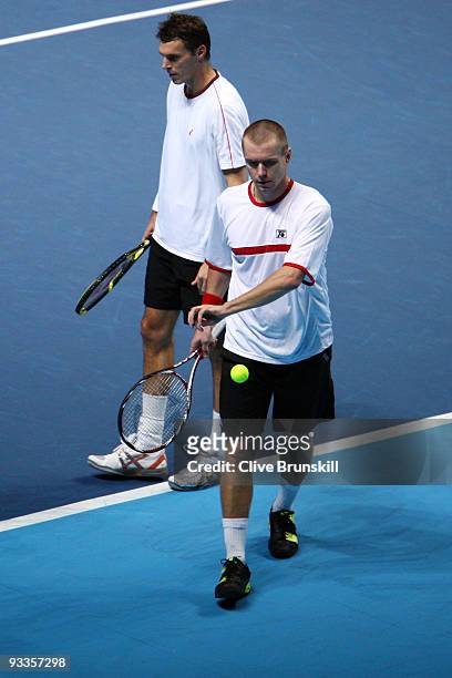 Frantisek Cermak of Czech Republic walks next to Michal Mertinak of Slovakia after they won the men's doubles second round match against Daniel...