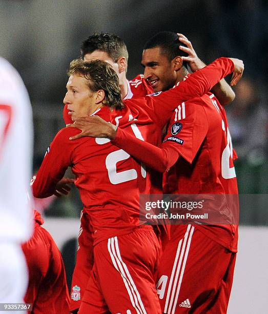 David Ngog of Liverpool celebrates with Lucas Leiva and captain Steven Gerrard after scoring a goal during the UEFA Champions League group E match...