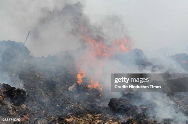 Ambernath dumping ground caught major fire on Saturday releasing thick smoke in the nearby areas, on March 17, 2018 in Mumbai, India. Two fire...