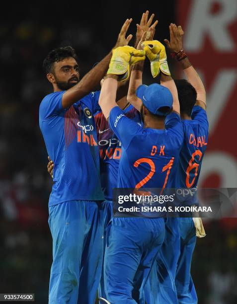 Indian cricketer Jaydev Unadkat celebrates with his teammates after he dismissed Bangladeshi cricketer Sabbir Rahman during the final Twenty20...