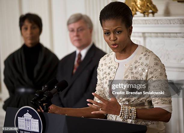 White House Social Secretary Desiree Rogers and White House Curator William Allman listen while First Lady Michelle Obama speaks at a preview for...