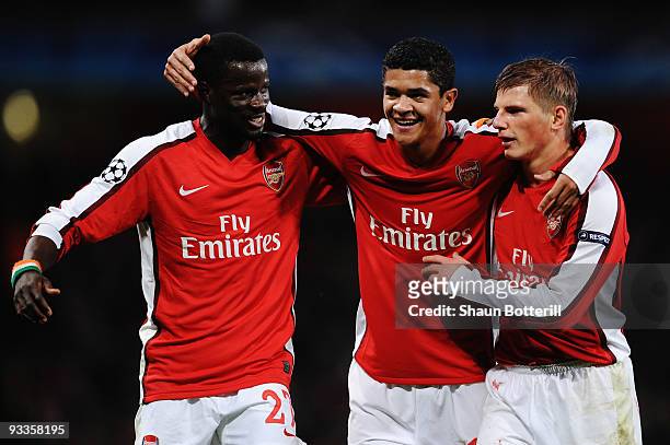 Emmanuel Eboue, Denilson and Andrei Arshavin of Arsenal celebrate Denilson's goal during the UEFA Champions League group H match between Arsenal and...
