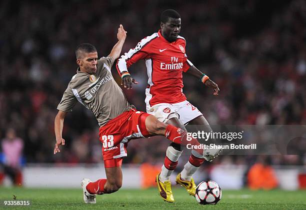 Emmanuel Eboue of Arsenal is challenged by Mehdi Carcela-Gonzalez of Standard Liege during the UEFA Champions League group H match between Arsenal...