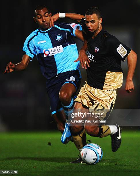 Kevin Betsy of Wycombe Wanderers battles for the ball with John Bostock of Brentford during the Coca-Cola League One match between Wycombe Wanderers...