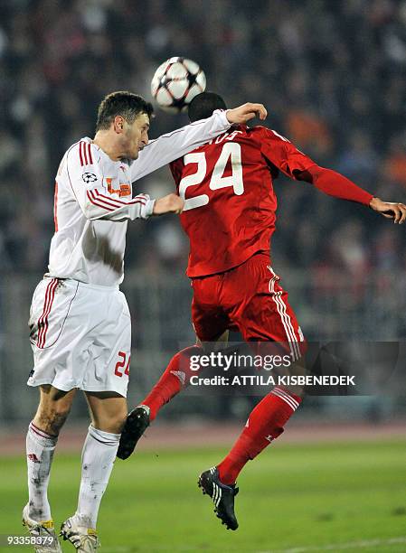 Liverpool's David Ngog heads the ball with Hungarian Mirsad Mijadinoski of VSC Debrecen in the Puskas stadium of Budapest on November 24, 2009 during...