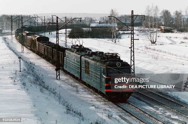 Train on the Trans-Siberian railway, snowy landscape, Russia.