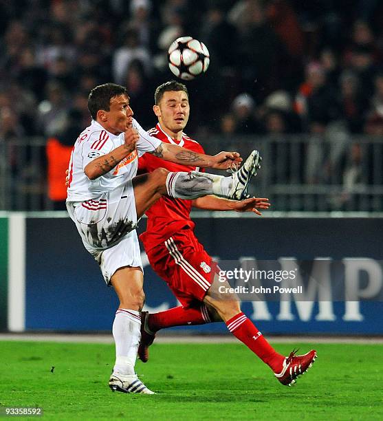 Fabio Aurelio of Liverpool competes with Gergely Rudolf of Debrecen during the UEFA Champions League group E match between Debrecen and Liverpool at...