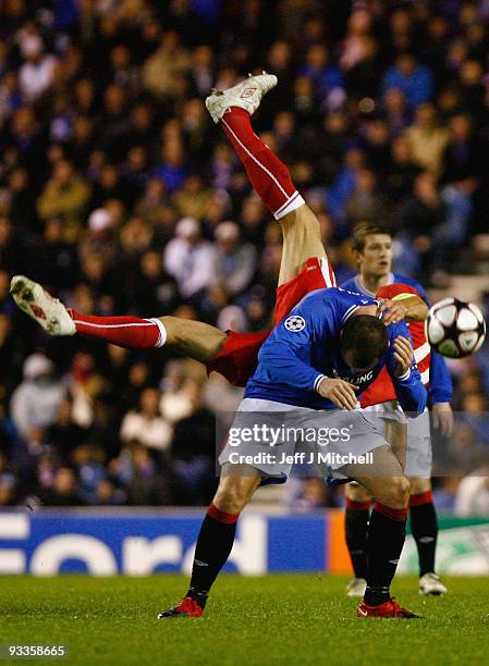 Kris Boyd of Rangers is tackled by Matthieu Delpierre of VfB Stuttgart during the UEFA Champions League Group G match between Rangers and VfB...