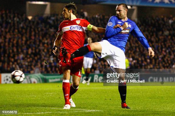 Kris Boyd of Rangers tackles Matthieu Delpierre of VfB Stuttgart during the UEFA Champions League Group G match between Rangers and VfB Stuttgart at...