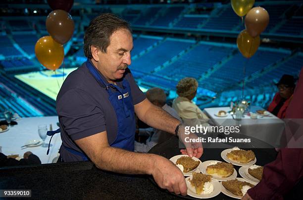 Ernie Grunfeld, President of the Washington Wizards, grabs a plate of apple pie to deliver it to a senior DC resident as part of the Thanksgiving...