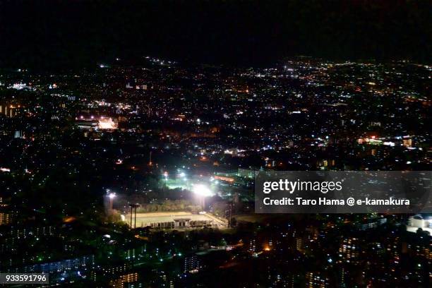 dazaifu city in fukuoka prefecture in japan night time aerial view from airplane - dazaifu city stockfoto's en -beelden