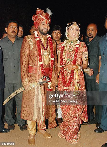 Bollywood actress Shilpa Shetty, right and London based businessman Raj Kundra pose for the media after their marriage ceremony in Khandala around...