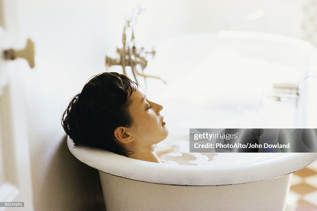 Woman soaking in bubble bath