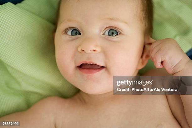 baby pulling on ear, smiling - pulling ear stock pictures, royalty-free photos & images