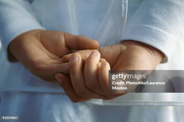 child with hands clasped behind back, close-up - mãos-atrás-das-costas imagens e fotografias de stock