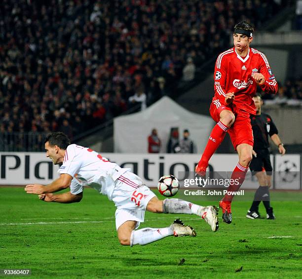 Daniel Agger of Liverpool goes up with Zoltan Kiss of Debrecen during the UEFA Champions League group E match between Debrecen and Liverpool at the...