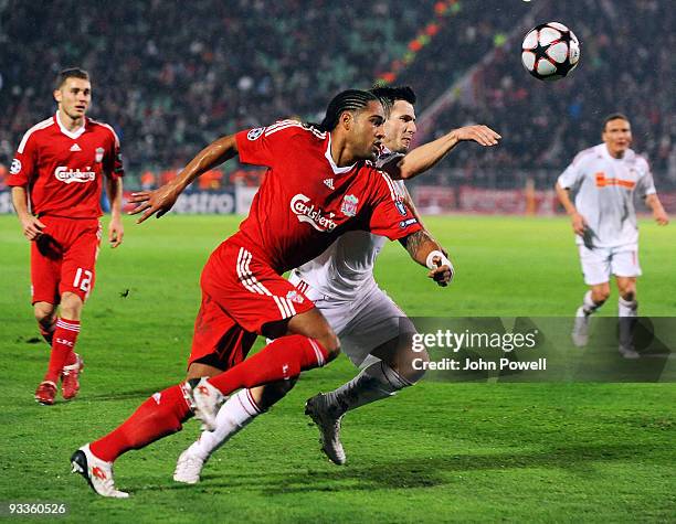 Glen Johnson of Liverpool battles with Mirsad Mijadinski of Debrecan during the UEFA Champions League group E match between Debrecen and Liverpool at...