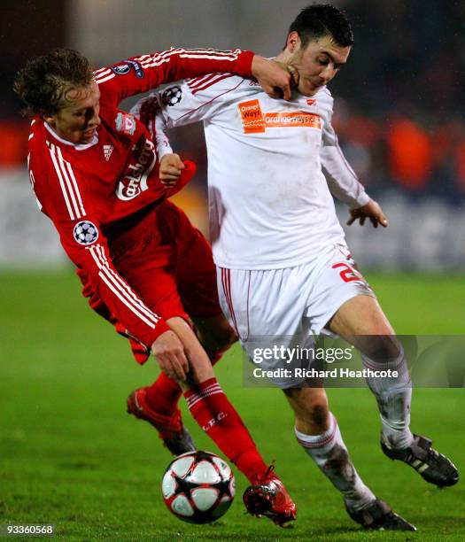 Lucas Leiva of Liverpool is tackled by Marcell Fodor of Debrecen during the UEFA Champions League group E match between Debrecen and Liverpool at the...