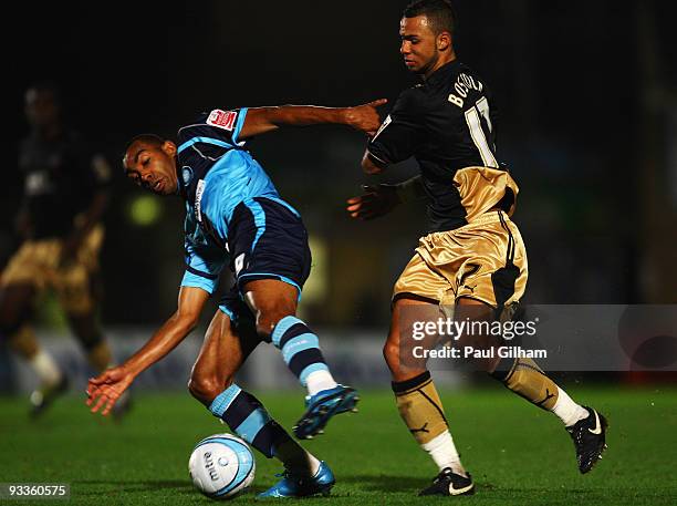 Kevin Betsy of Wycombe Wanderers battles for the ball with John Bostock of Brentford during the Coca-Cola League One match between Wycombe Wanderers...