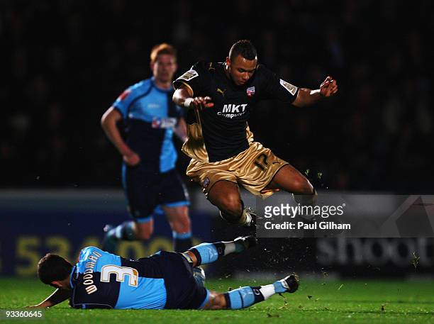 Craig Woodman of Wycombe Wanderers battles for the ball with John Bostock of Brentford during the Coca-Cola League One match between Wycombe...