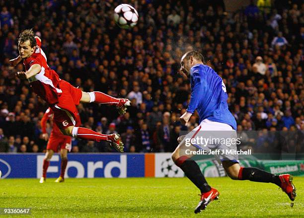 Kris Boyd of Rangers is challenged by Georg Niedermeier of VfB Stuttgart during the UEFA Champions League Group G match between Rangers and VfB...