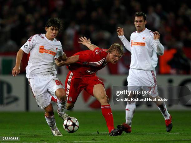 Dirk Kuyt of Liverpool is tackled by Zsolt Laczko of Debrecen during the UEFA Champions League group E match between Debrecen and Liverpool at the...