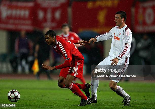 David Ngog of Liverpool holds off Norbert Meszaros of Debrecen during the UEFA Champions League group E match between Debrecen and Liverpool at the...
